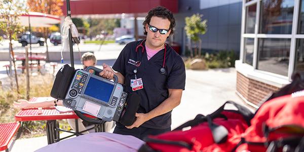 paramedic standing outside with gear